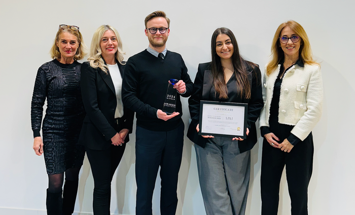 Global Elite Awards winners with certificate and trophy